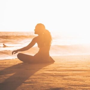 Yoga by the ocean at sunset